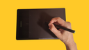 pen tablet yellow background